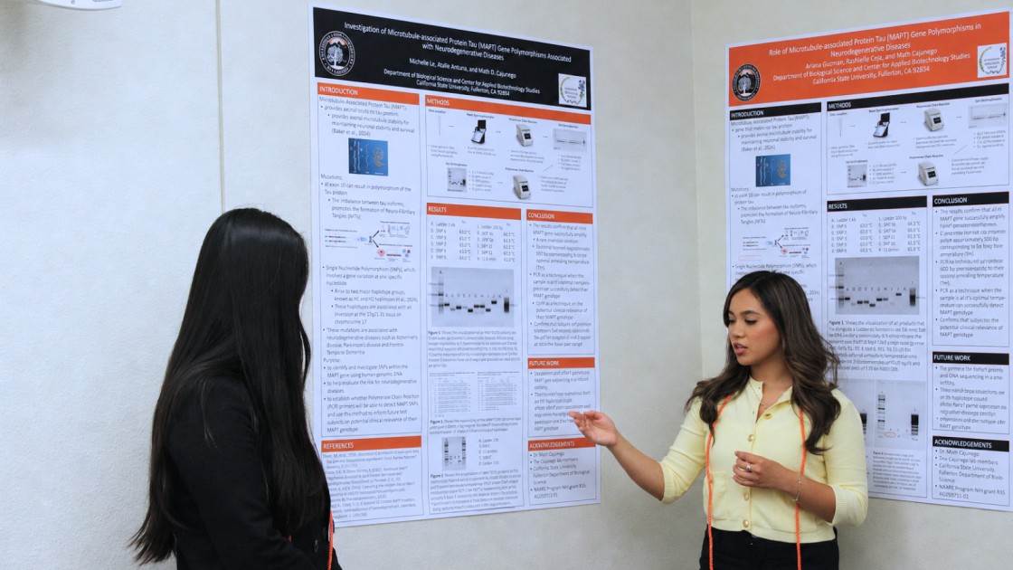 Two students presenting their research